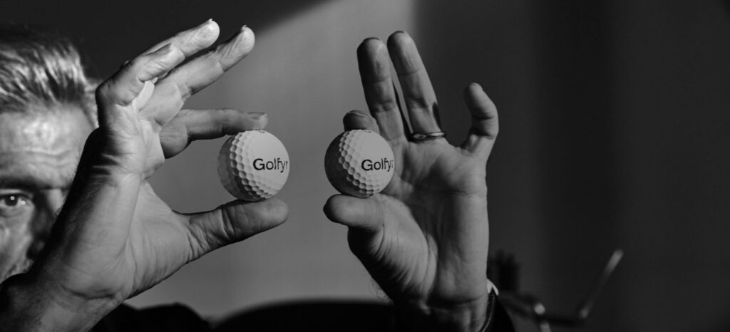 Alfredo Häberli holding two golf balls in front of him as if they were eyes