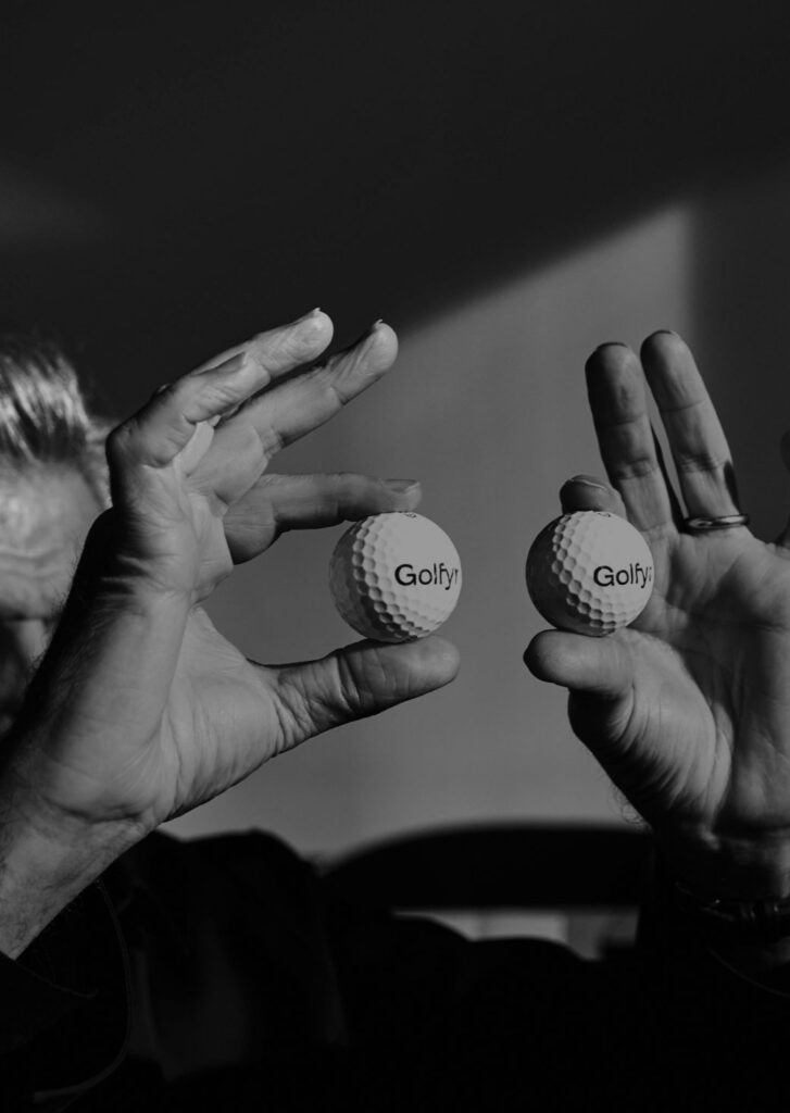 Alfredo Häberli holding two golf balls in front of him as if they were eyes